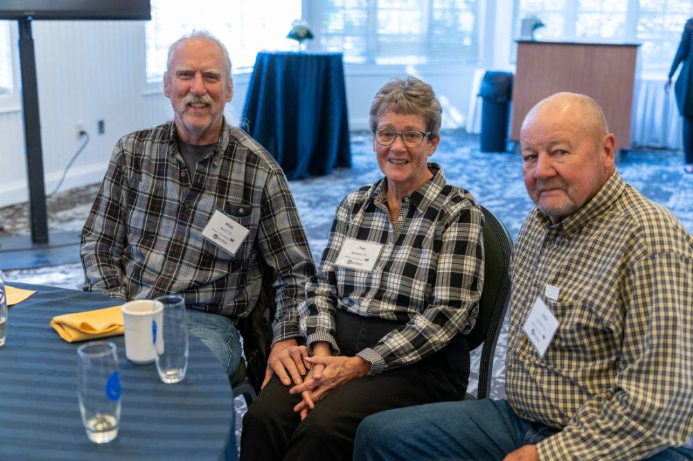 Three alumni sitting together.